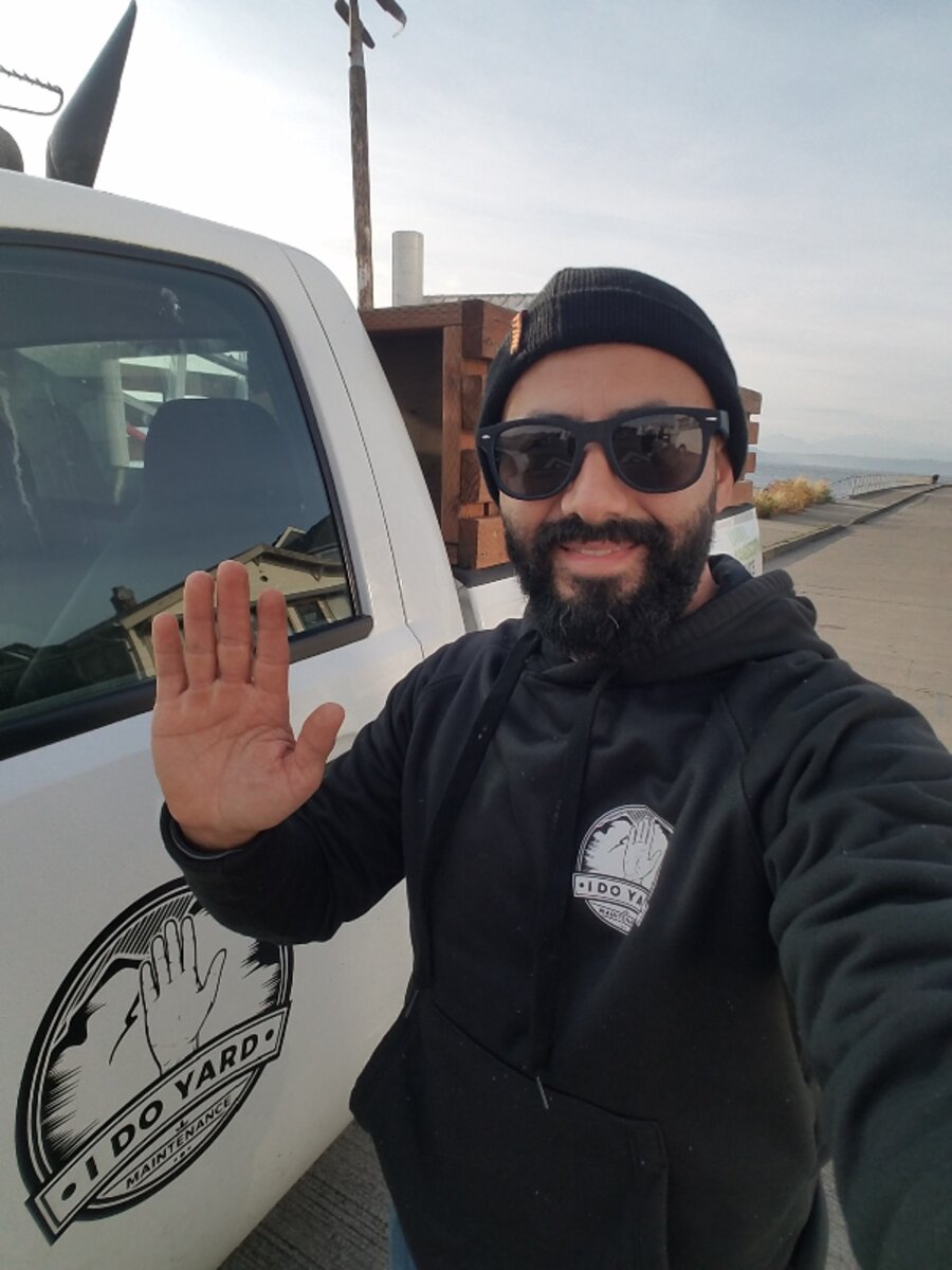Sergio Gurrola, owner of I Do Yard Maintenance, next to the company truck